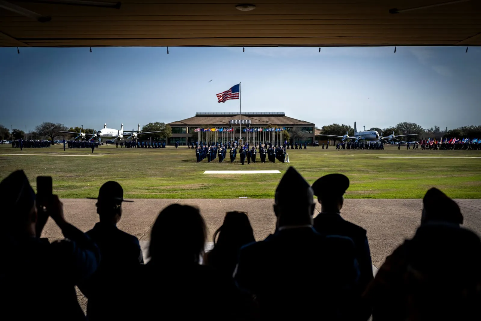 Families watching BMT graduation parade from bleachers at JBSA-Lackland
